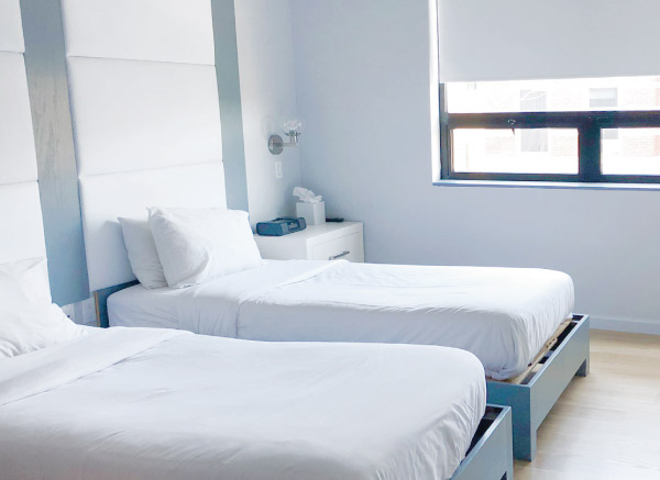 A room with two twin beds side by side